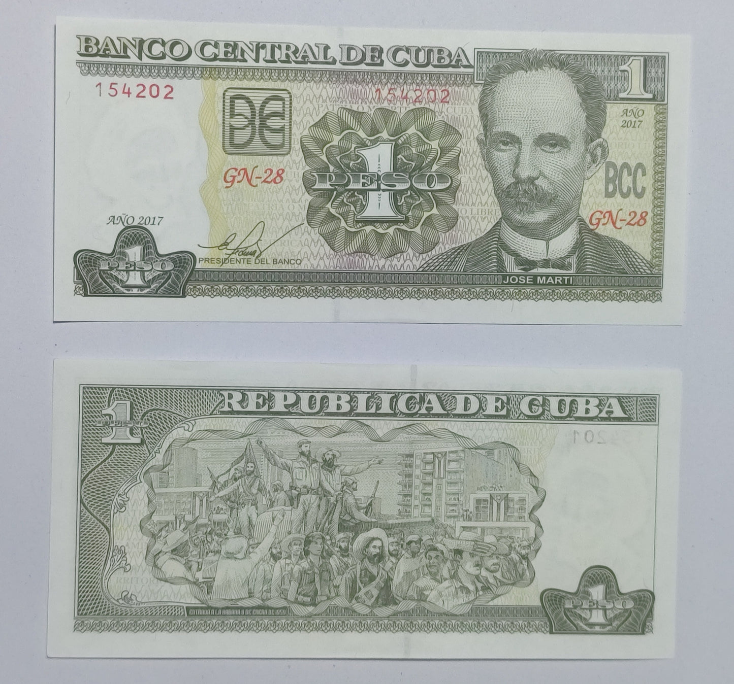 Cuban banknote with a portrait and national scene on a light gray background